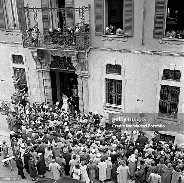 Italian countess Emanuela Castelbarco in a wedding dress leaving the house of her grandfather and Italian conductor Arturo Toscanini, on via Durini...