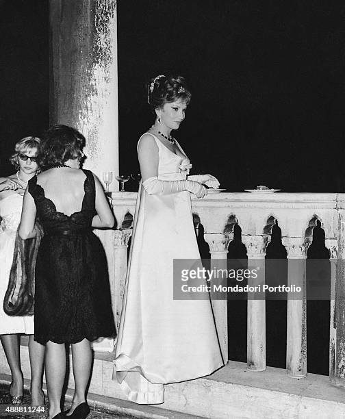 Italian actress Gina Lollobrigida , very elegant in Bulgari earrings and necklace, attending a party held for the 23th Venice International Film...