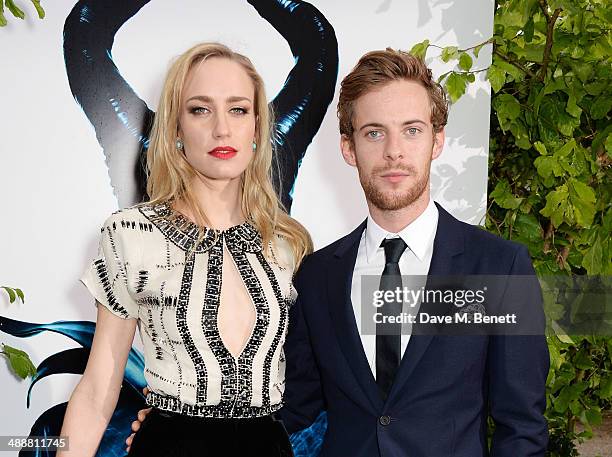 Ruta Gedmintas and Luke Treadaway arrive at a private reception as costumes and props from Disney's "Maleficent" are exhibited in support of Great...