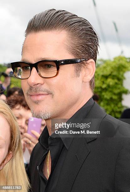 Brad Pitt arrives at a private reception as costumes and props from Disney's "Maleficent" are exhibited in support of Great Ormond Street Hospital at...