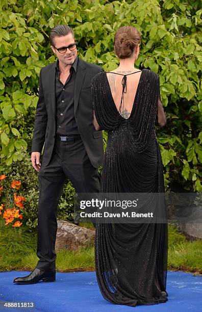 Brad Pitt and Angelina Jolie arrive at a private reception as costumes and props from Disney's "Maleficent" are exhibited in support of Great Ormond...