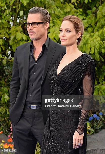 Brad Pitt and Angelina Jolie arrive at a private reception as costumes and props from Disney's "Maleficent" are exhibited in support of Great Ormond...