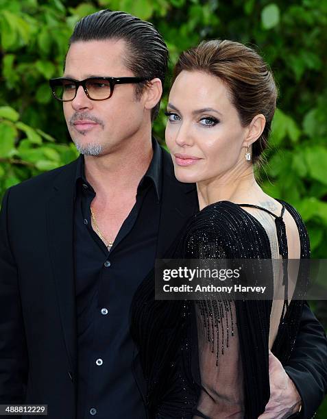 Brad Pitt and Angelina Jolie attend a private reception as costumes and props from Disney's "Maleficent" are exhibited in support of Great Ormond...