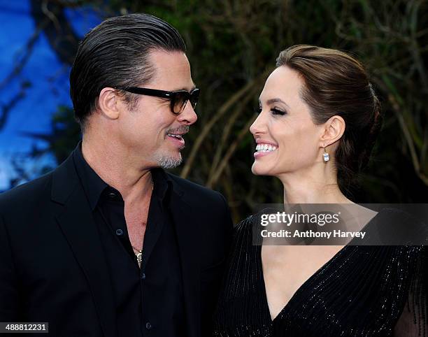 Brad Pitt and Angelina Jolie attend a private reception as costumes and props from Disney's "Maleficent" are exhibited in support of Great Ormond...