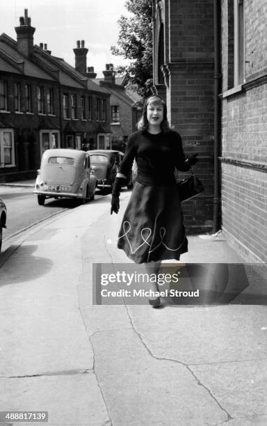 Roberta Cowell walking down a street, 1958. Cowell, a former racing driver and RAF pilot was the first person to undergo gender reassignment surgery...