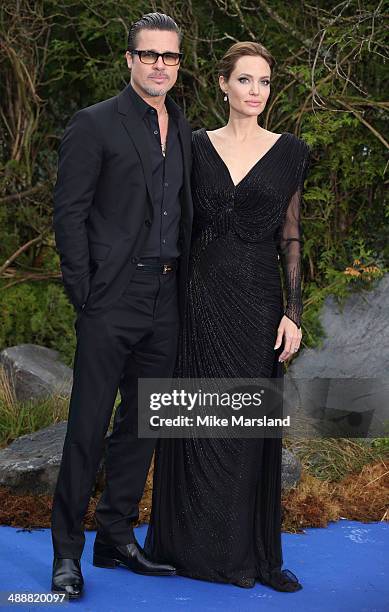 Angelina Jolie and Brad Pitt attend a private reception as costumes and props from Disney's "Maleficent" are exhibited in support of Great Ormond...