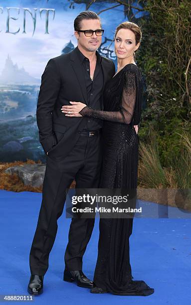 Angelina Jolie and Brad Pitt attend a private reception as costumes and props from Disney's "Maleficent" are exhibited in support of Great Ormond...