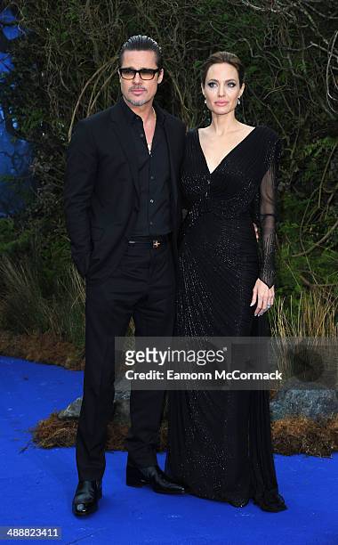 Brad Pitt and Angelina Jolie attends a private reception as costumes and props from Disney's "Maleficent" are exhibited in support of Great Ormond...