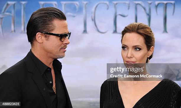 Brad Pitt and Angelina Jolie attends a private reception as costumes and props from Disney's "Maleficent" are exhibited in support of Great Ormond...