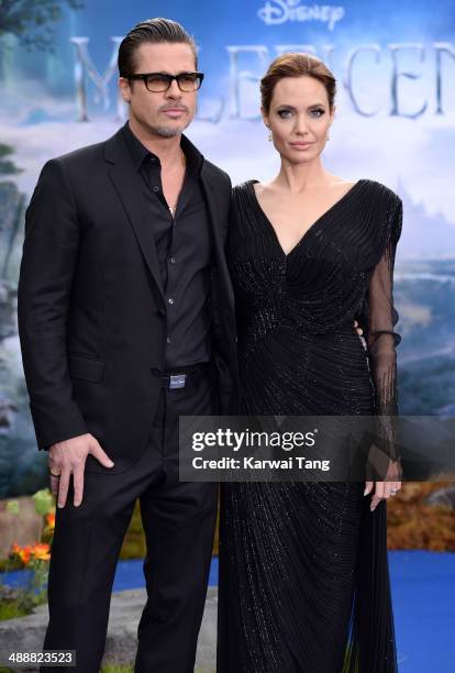 Brad Pitt and Angelina Jolie attend a private reception as costumes and props from Disney's "Maleficent" are exhibited in support of Great Ormond...