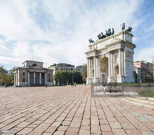 Long shot of Simplon Square, almost desert, at the entrance of the homonymous park, one of the green areas most famous in Milan; the white monument...