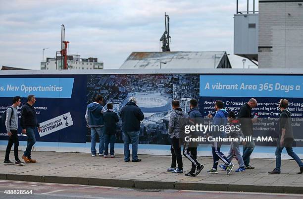 Fans look at the plans for the new Tottenham Hotspur stadium outside before the UEFA Europa League match between Tottenham Hotspur and Qarabag at...