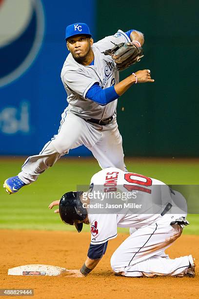 Shortstop Alcides Escobar of the Kansas City Royals throws to first as Yan Gomes of the Cleveland Indians is out at second during the fifth inning at...