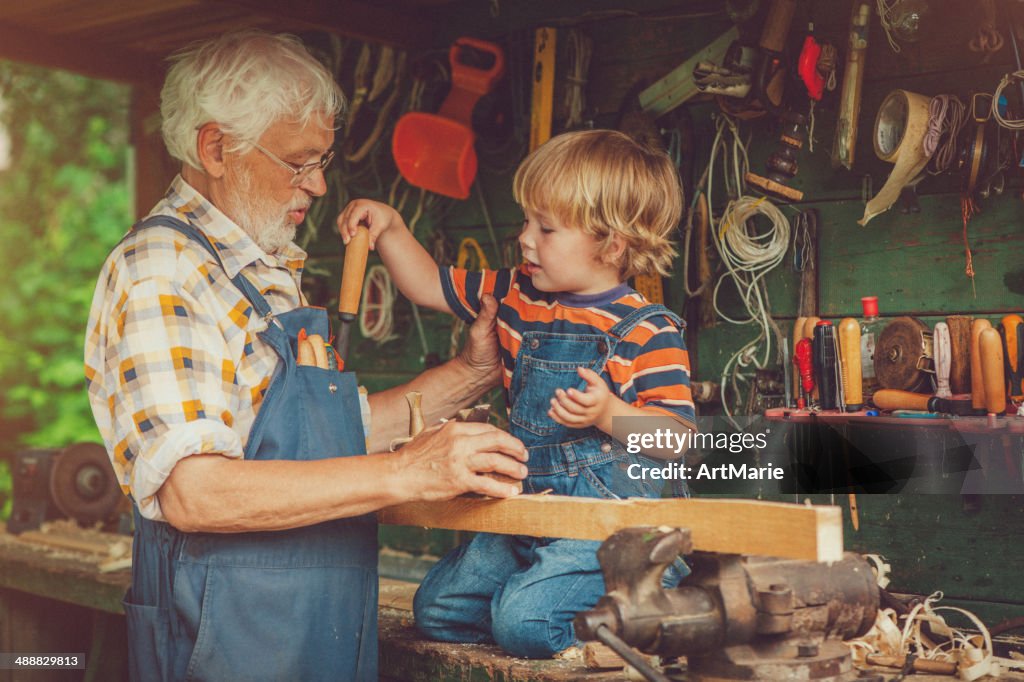 Grandfather and grandson in workshop