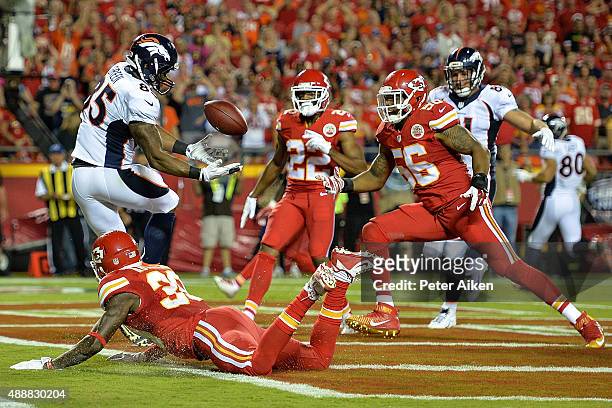 Virgil Green of the Denver Broncos makes a catch for a touchdown around defenders Derrick Johnson, Marcus Peters, and Husain Abdullah of the Kansas...