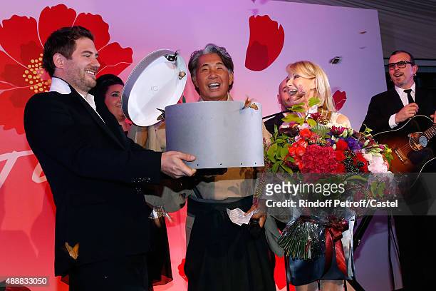 Kenzo Takada opens a gift box freeing 200 Butterflies during the Kenzo Takada's 50 Years Of Life in Paris Celebration at Restaurant Le Pre Catelan on...
