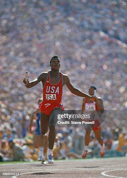 American athlete Carl Lewis crossing the line to win the final of the Men's 4 x 100 metres relay at the Los Angeles Memorial Coliseum during the...