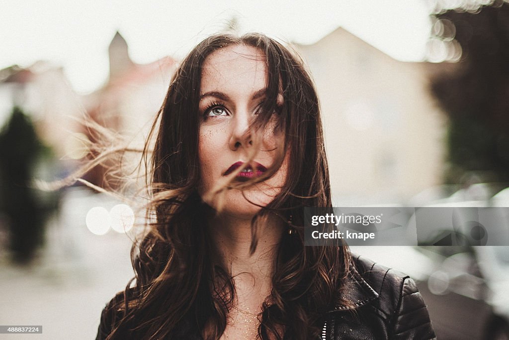 Candid portrait of beautiful woman in wind