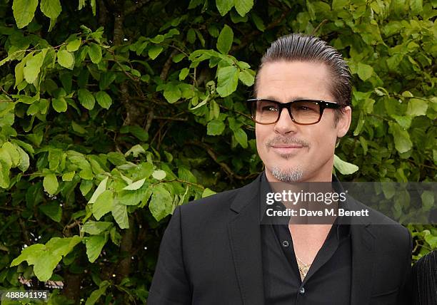 Brad Pitt arrives at a private reception as costumes and props from Disney's "Maleficent" are exhibited in support of Great Ormond Street Hospital at...