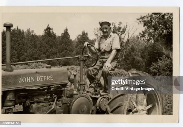 Farmer on a John Deere tractor, circa 1935.