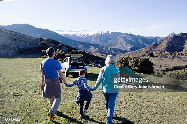 grandparents camping with grandson - holding hands in car stock pictures, royalty-free photos & images