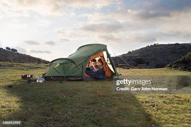 two brothers waking up inside tent - camping imagens e fotografias de stock