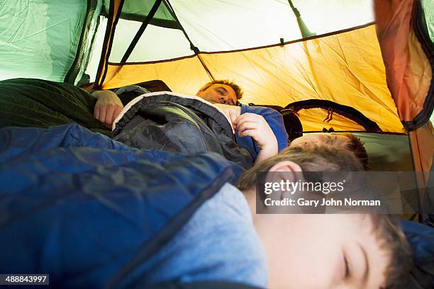 grandad and grandsons sleeping in tent - camping indoors stock pictures, royalty-free photos & images