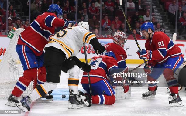 Matt Fraser of the Boston Bruins scores the winning goal on goalie Carey Price while being challenged by Douglas Murray, Mike Weaver and Lars Eller...