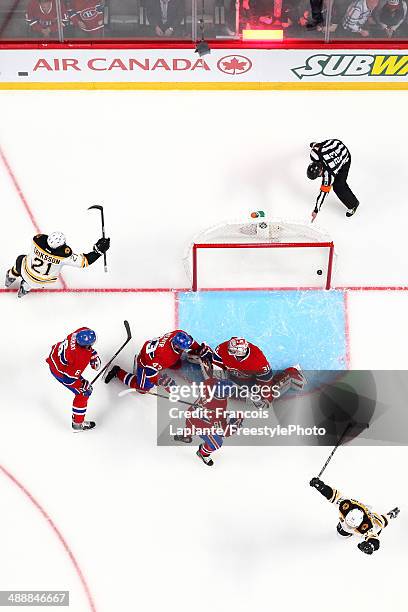 Carl Soderberg and Loui Eriksson of the Boston Bruins celebrate their overtime win against Carey Price, Douglas Murray, Mike Weaver and Lars Eller of...