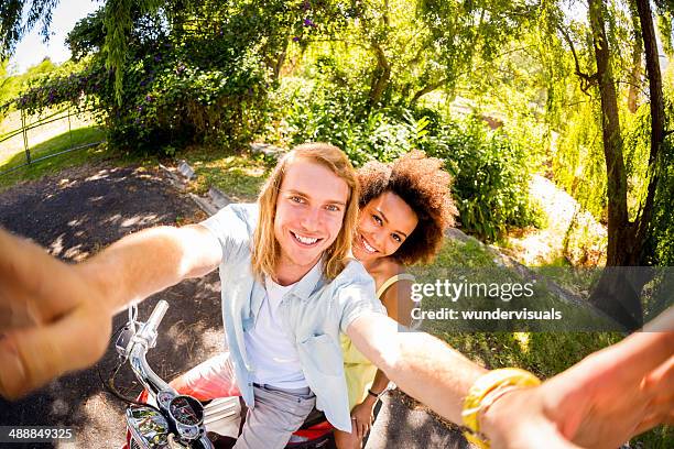young couple on scooter taking selfie - fish eye lens stock pictures, royalty-free photos & images
