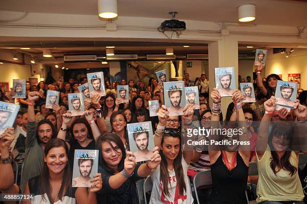 The fans of Nek show copy of his book. Filippo Neviani also known as "Nek" , an Italian singer presents a new book called Lettera a mia figlia...