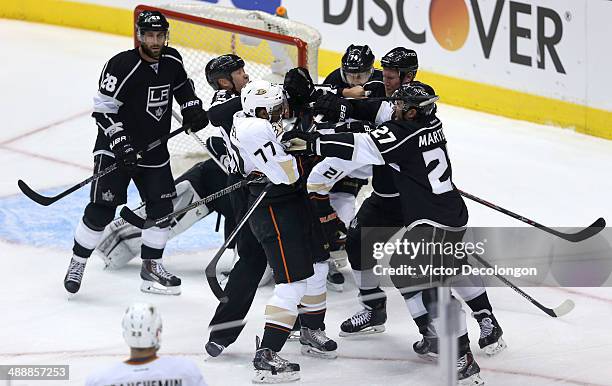 Dwight King, Matt Greene and Alec Martinez of the Los Angeles Kings tussle with Devante Smith-Pelly of the Anaheim Ducks after the whislte as NHL...