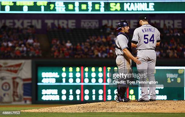 Michael McKenry of the Colorado Rockies talks with Tommy Kahnle of the Colorado Rockies on the mound as the Rockies take on the Texas Rangers in the...