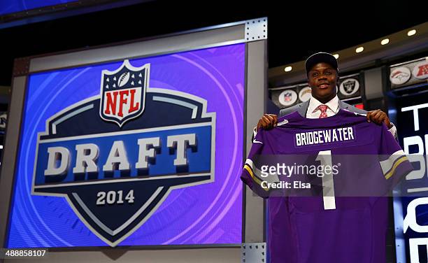 Teddy Bridgewater of the Louisville Cardinals poses with a jersey after he was picked overall by the Minnesota Vikings during the first round of the...