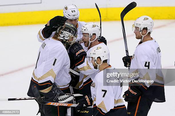 Goaltender Jonas Hiller of the Anaheim Ducks is congratulated by teammates Bryan Allen, Saku Koivu, Andrew Cogliano and Cam Fowler after they...