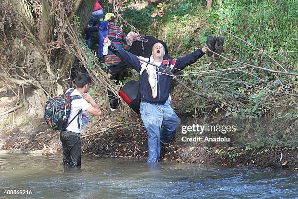 Refugees who try to go to the capital Ljubljana on foot walk in the Sutla river in Brezice, Slovenia on September 18, 2015. Slovenia intends to...