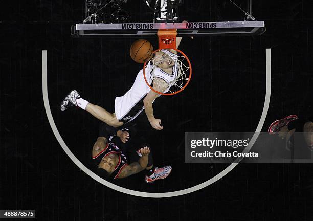 Manu Ginobili of the San Antonio Spurs watches his shot while Damian Lillard of the Portland Trail Blazers defends in Game Two of the Western...