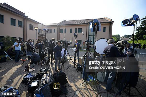 Journalists wait oustside at the Catholic hospice "Sacra Famiglia" in Cesano Boscone before the arrival of Italian former Prime Minister Silvio...