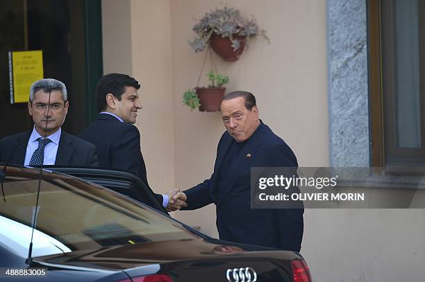 Italian former Prime Minister Silvio Berlusconi arrives at the Catholic hospice "Sacra Famiglia" in Cesano Boscone to begin community service for tax...