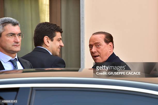 Italian former Prime Minister Silvio Berlusconi arrives at the Catholic hospice "Sacra Famiglia" in Cesano Boscone to begin community service for tax...