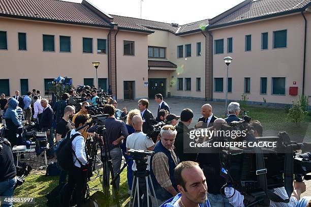 Journalists wait for the arrival of Italian former Prime Minister Silvio Berlusconi at the Catholic hospice "Sacra Famiglia" in Cesano Boscone where...