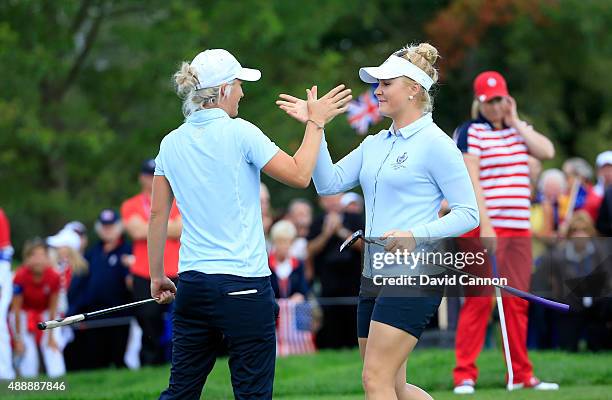 Charley Hull and Melissa Reid of the European Team celebrate a 2&1 win against Brittany Lincicome and Michelle Wie of the United States on the 17th...