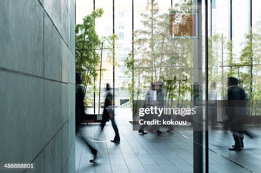 Business person walking in a urban building Business person walking in a urban building