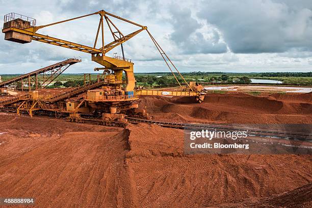 Giant excavator operates outside a bauxite treatment plant operated by Compagnie des Bauxites de Guinee in Kamsar, Guinea, on Monday, Sept. 7, 2015....