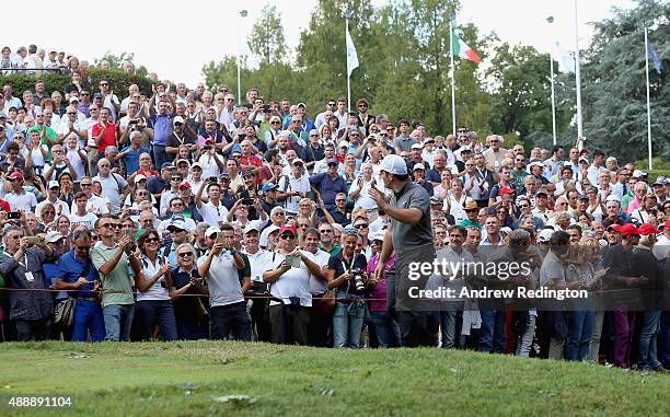 Francesco Molinari of Italy waves to the crowd as they welcome him onto the first tee during the second round of the 72nd Open d'Italia at Golf Club...