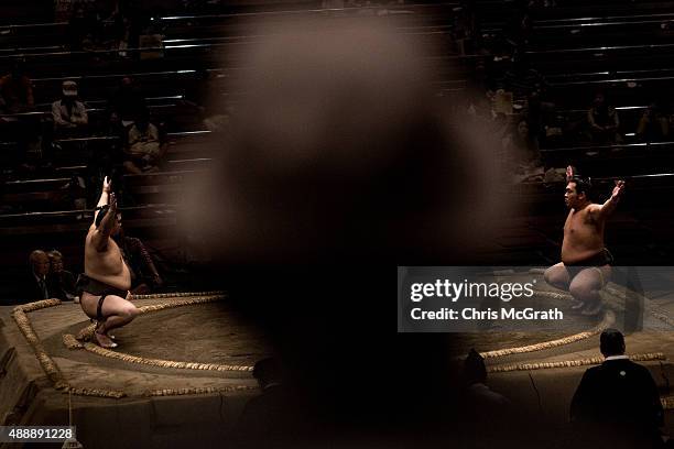 Man watches a fight during the Tokyo Grand Sumo tournament at the Ryogoku Kokugikan on September 17, 2015 in Tokyo, Japan. Japanese Sumo is an...