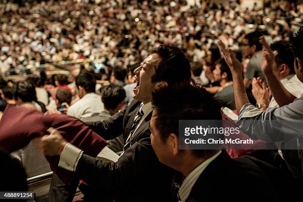 Spectator reacts to the outcome of a fight during the Tokyo Grand Sumo tournament at the Ryogoku Kokugikan on September 17, 2015 in Tokyo, Japan....