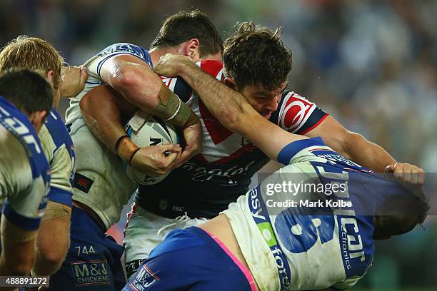 Aidern Guerra of the Roosters fends away Josh Reynolds of the Bulldogs during the First NRL Semi Final match between the Sydney Roosters and the...