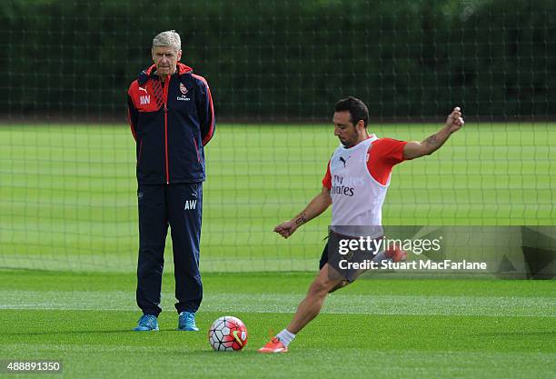 Arsenal manager Arsene Wenger watches Santi Cazorla during a training session at London Colney on September 18, 2015 in St Albans, England.