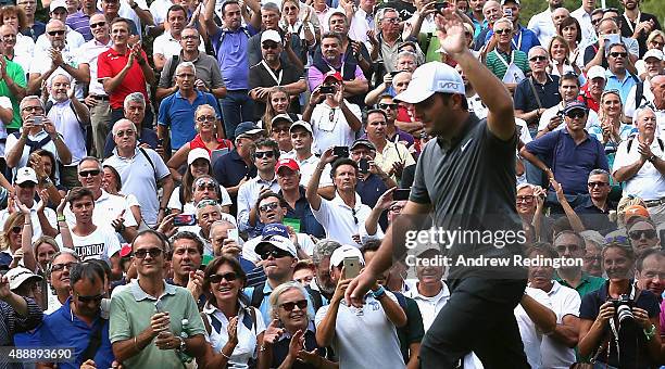 Francesco Molinari of Italy waves to the crowd as they welcome him onto the first tee during the second round of the 72nd Open d'Italia at Golf Club...
